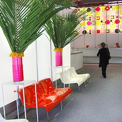 Tall, shiny hot pink vases filled with giant palm fronds decorated the entrance to the show's registration area.