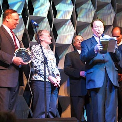 BiZBash CEO David Adler (left) and president Richard Aaron presented Kathleen Moore with the global meeting and event planning award.