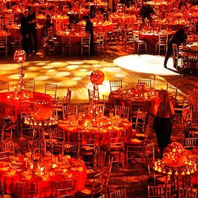 Avi Adler's carved pumpkins and votive candles decorated the tables at the Museum of Art and Design's Visionaries awards at the Hilton New York. Lux Lighting projected orange and yellow pumpkin-shaped gobos onto the dance floor. (Photo by Eric Weiss)