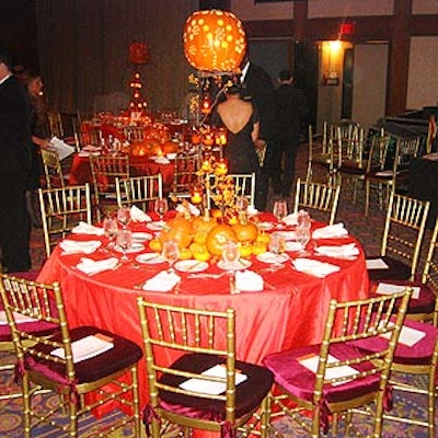 Avi Adler's centerpiece decor featured large carved pumpkins displayed on top of large iron stands decorated with votive candles and berry branches.