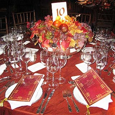 On the tables, arrangements of fruit or mums spilled over the top of large silver bowls. The event's program, designed to look like an antique book, sat atop each guest's plate.