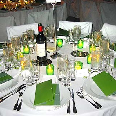 The all-white tables were dotted with the event's green programs and votives in green glass cups.