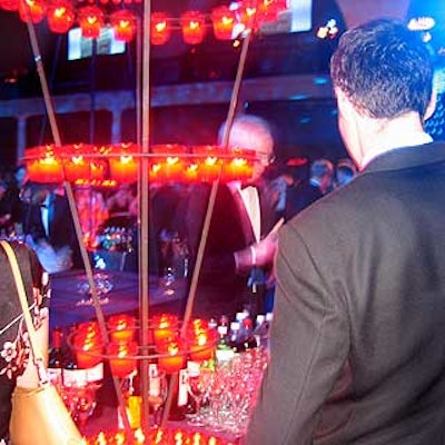 Avi Adler's four-tiered circular sculptures made of glowing red votives illuminated the bar.