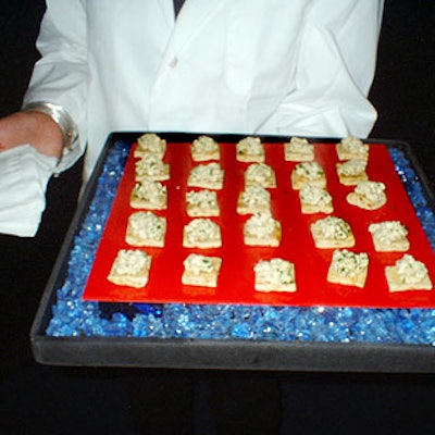 For the U.S. Ski and Snowboard Association Ball at the Hammerstein Ballroom, The Catering Company decorated the hors d'oeuvres trays with shiny, brightly colored paper and surrounded the food with clear, jagged pebbles resembling ice.