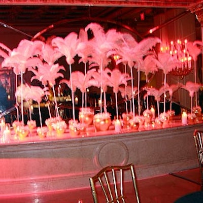 Fluffy white feathers inside gold vases topped a low wall.