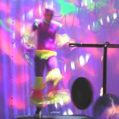 A dancer gyrated to the hypnotic beats under a rainbow of lights.