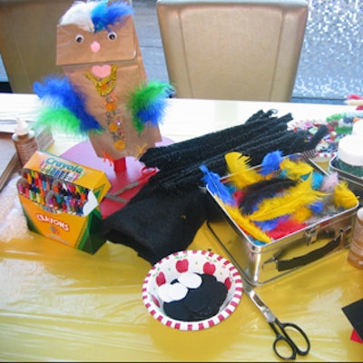 Art supplies covered the table at the 'Paperbag Pet' activity station.