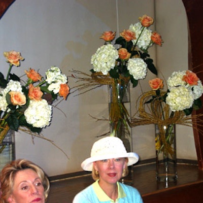 Flower arrangements with yellow roses and white hydrangea decorated the Hamptons-inspired area.