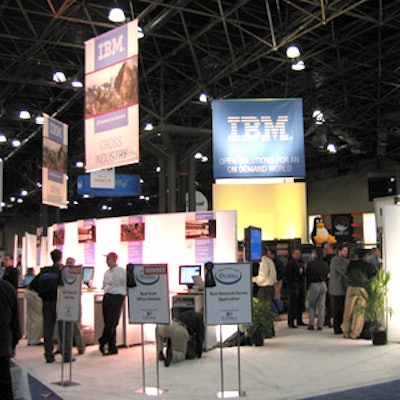 A frosted white wall surrounded IBM's pastel-hued booth designed and built by George P. Johnson.