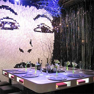 A collage of large sequins showed Cyndi Lauper's face, and pictures of pop icons—including Madonna, Michael Jackson and Cher—adorned the plates in David Rockwell's take-off on celebrity culture. Books covered in red velvet and labeled 'Secrets' sat inside individual slots in the table, and small test tube-sized vases sat in holes in its surface.