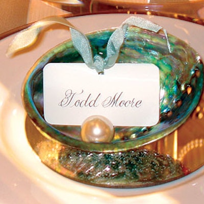 Designer Todd Moore marked each place at the Schumacher table with a name card decorated with ribbon and a giant faux pearl in an abalone shell.