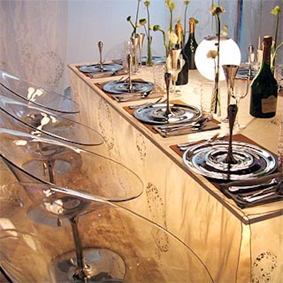 Surprise by Design host Robert Verdi designed a bubbly-inspired table for event sponsor Champagne Taittinger. Sheer white fabric covered a transparent rectangular table paired with Philippe Starck chairs—which, truth be told, looked more like martini glasses than champagne flutes.