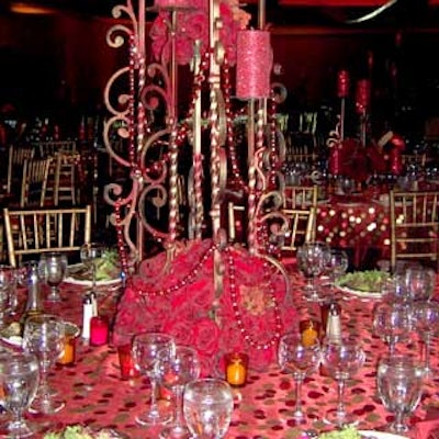 Iron centerpieces with flowers and candles were the focal point of each table.