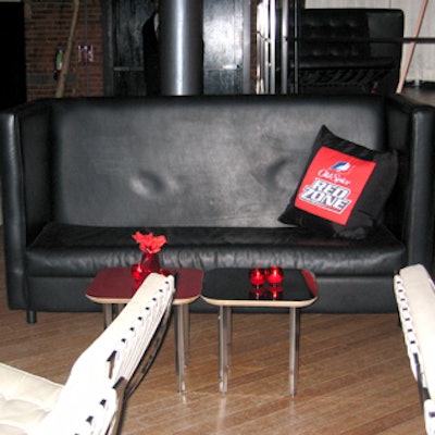Red Zone-branded throw pillows graced black leather couches and white leather chairs.