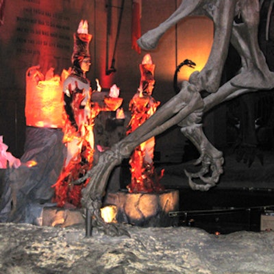 Flame-costumed performers from Dance Trance stood at the base of Barosaurus skeleton in the Theodore Roosevelt Rotunda at the American Museum of Natural History's Winter Dance.