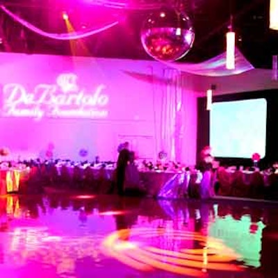 Á La Carte's in-house planning and production team transformed the venue into a mod setting complete with disco ball and pink vinyl dance floor.