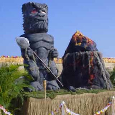 A Polynesian statue and volcano added ambiance to the Hawaiian-themed event.