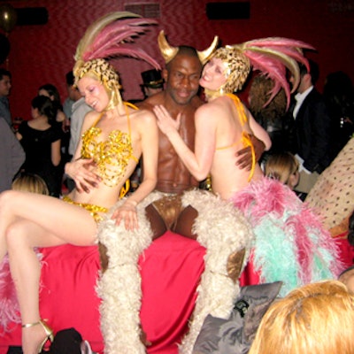 Showgirls cavorted with nearly naked male models in the back room at Marquee at Nylon magazine's fifth anniversary party.