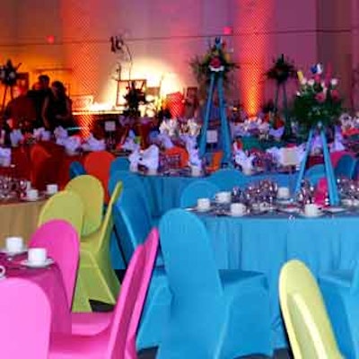 Room décor consisted of brightly colored linens, unique centerpieces and chain link fence used as backrop.