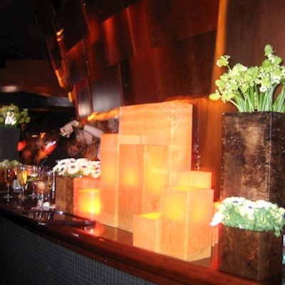 Large pillar candles and wood vases filled with white and green flowers decorated the bar at the International Neuroscience Foundation's benefit at Blvd.