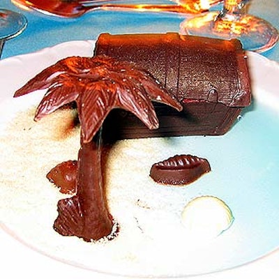 The almost-too-pretty-to-eat dessert was a chocolate palm tree on a beach of white chocolate sand beside a chocolate treasure chest containing three tiny scoops of sorbet.