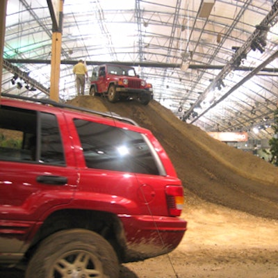 Jeep representatives drove show attendees over a giant mountain of dirt and through mud pits and gravelly terrain inside the Javits Center's north pavilion.