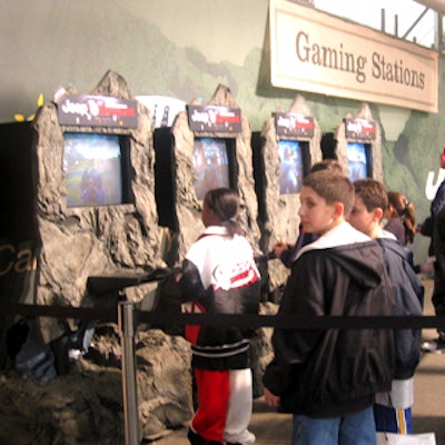 Teenagers too big for the mini Jeeps lined up to play branded driving video games decorated with rock-like casings.