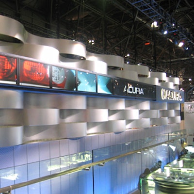 Acura's signage included undulating strips of brushed metal paired with a row of flat-screen monitors.