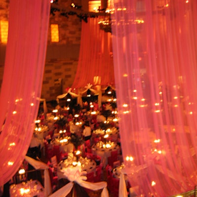 Antony Todd topped tables in the center of the room with three-tiered black Lucite towers filled with water and floating candles.