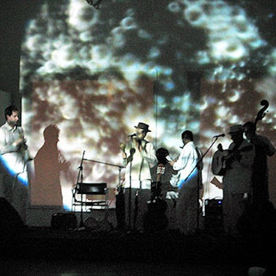 Latin jazz band Jose Conde y Ola Fresca dressed in white to blend in with the changing decor while performing for the young crowd.