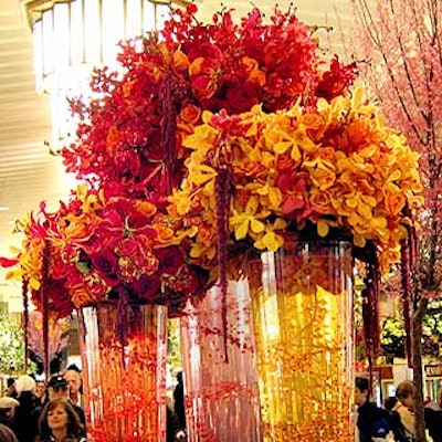 For his bouquet, James Francois-Pijuan of Francois-Pijuan Floral Design & Event Decor created a grouping of three glass containers of different heights and lavished them with flowers in shades of yellow, red and orange. The interiors of the vases included coils of colored glass jewels. The piece contained cymbidium, dendrobium and James Story orchids, as well as three types of roses, gloriosas and hanging amaranthus.