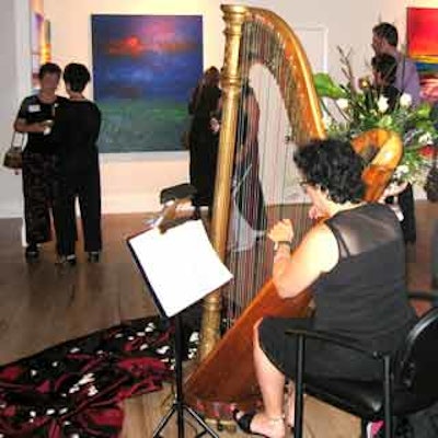 Guests mingled and wandered about as harpist Deborah Fleisher strummed soothing tunes.
