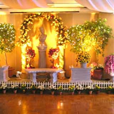 Flowers, trees and garden sculptures decorated the main room of the Miami Beach Rod & Reel Club for the Baptist Hospital Nursing Scholars Program dinner event.