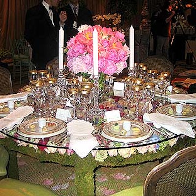More than 1,400 fresh, pastel-colored roses, along with ranunculi, anenomes and viburnum, were carefully arranged atop a bed of moss, blooms facing up, across the entire surface of the table. A sheet of glass, along with china and tableware, were laid on top to create a magical, garden-like effect.