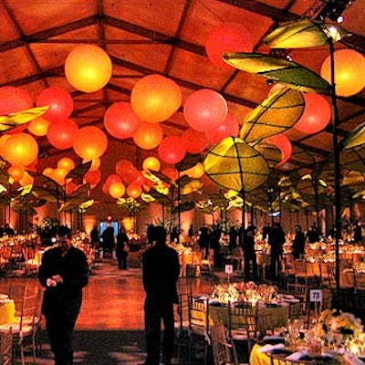 Bentley Meeker lit the Tent at Damrosch Park for the American Ballet Theatre's gala with an orange glow. Bill Tansey created tall large-leafed green structures that towered over tabletops.