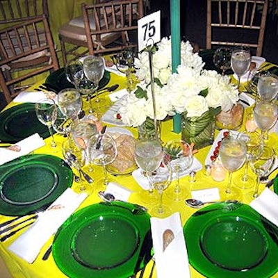 Restaurant Associates served dinner at place settings of clear green plates on lemon-colored tablecloths.
