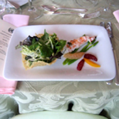 Aramark preset the first course, a langoustine and seasonal citrus salad with wild asparagus and baby spring field greens.