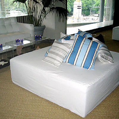 Lounge seating included white leather couches and low white bed seats covered with throw pillows.