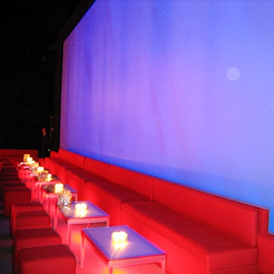 Red lounge furniture in modern shapes provided seating beneath two giant video walls.