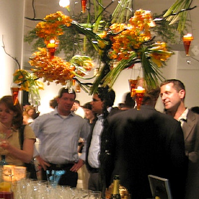 Candlelight chandeliers swathed in orange flowers hung above the bar.