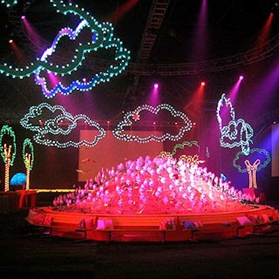 A giant mound of plastic grass and 420 pinwheel daisies filled the center of the cocktail area. Yellow park benches dotted with plaid, pastel and polka dotted-pillows skirted the mound.