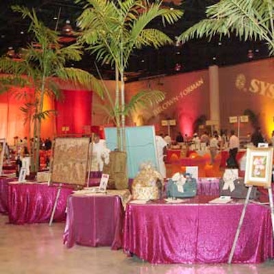 Raspberry-colored linens helped to draw attention to the numerous silent auction items.