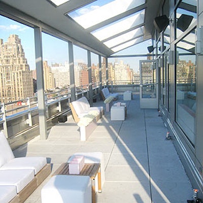 Short white tables and low chairs in baby pink covers decorated one side of the terrace on the rooftop of the Gansevoort Hotel for the launch of Calvin Klein's new Eternity Moment fragrance.