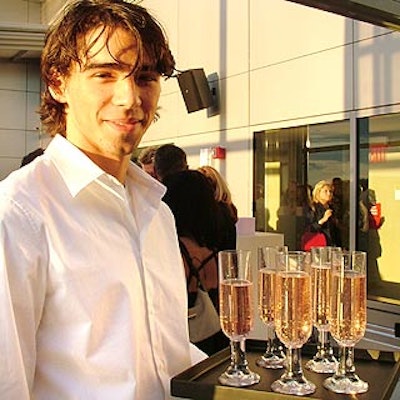 Servers offered flutes of bubbly pink cocktails to match the event's soft pink color scheme.