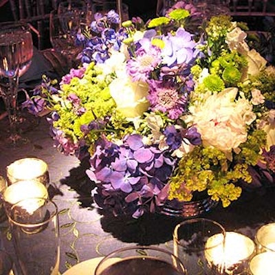 Robert Clark created centerpieces of phlox, hydrangeas, peonies, lady's mantle and hermit mums for the blue cloth and green trellis-embroidered, organza- covered tables.