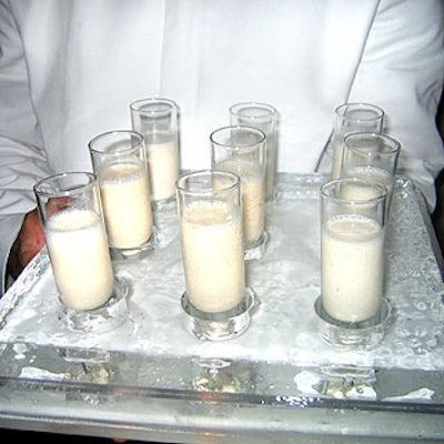 Waiters in white from Olivier Cheng Catering and Events served White Russian cocktails on trays made of ice.