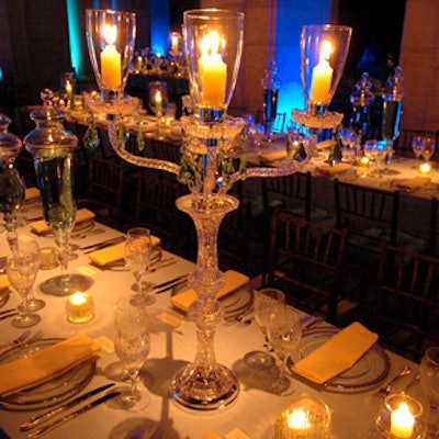 In the dining room, crystal and glass vases and containers in assorted shapes and textures added sparkle to a Swarovski crystal light sculpture and candelabra.
