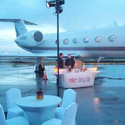 White spandex-covered tables and chairs from Le Basque provided guests a place to rest their food and feet