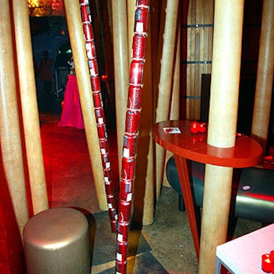 Curving towers made of cans of Coca-Cola's new mid-calorie soda, C2, mixed with the poles in one of Crobar's lounges.