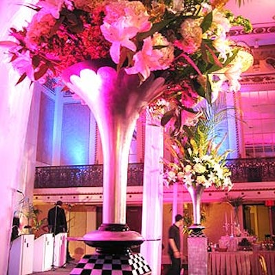 Two arrangements of hydrangeas, casablancas, snap dragons, calla lilies and palms in silver Art Deco-style vases flanked the dance floor.
